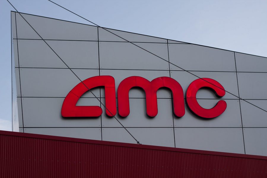 A large logo for AMC theaters on the side of an AMC theater.