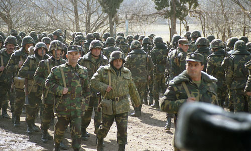 Several uniformed Armenian soldiers are standing in rows outside in preparation for battle.