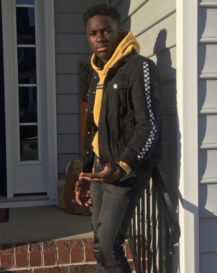 Xavier Nora stands on the steps of a house.