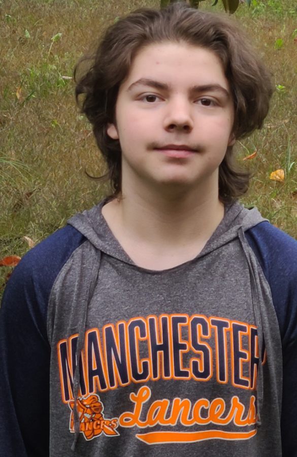 James Baran standing outside with a Manchester Lancers shirt