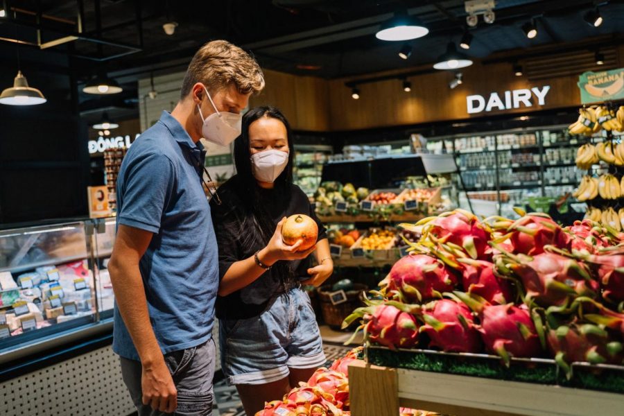 Shoppers in a grocery store with face masks on