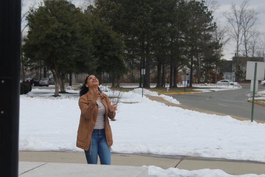 A student playing in the snow outside of Manchester