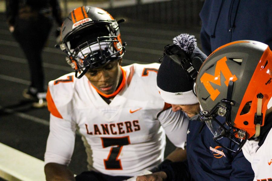 A MHS football player sitting on the bench